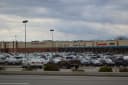 Cars fill the parking lot in front of a row of stores at a shopping centre in Cranberry Township, Pennsylvania, under a heavy grey sky