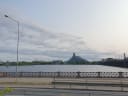 The National Library of Latvia and the Stone Bridge seen across the Daugava river in Riga under a pale evening sky