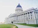The Utah State Capitol in Salt Lake City, its blue dome and Corinthian columns under a pale morning sky