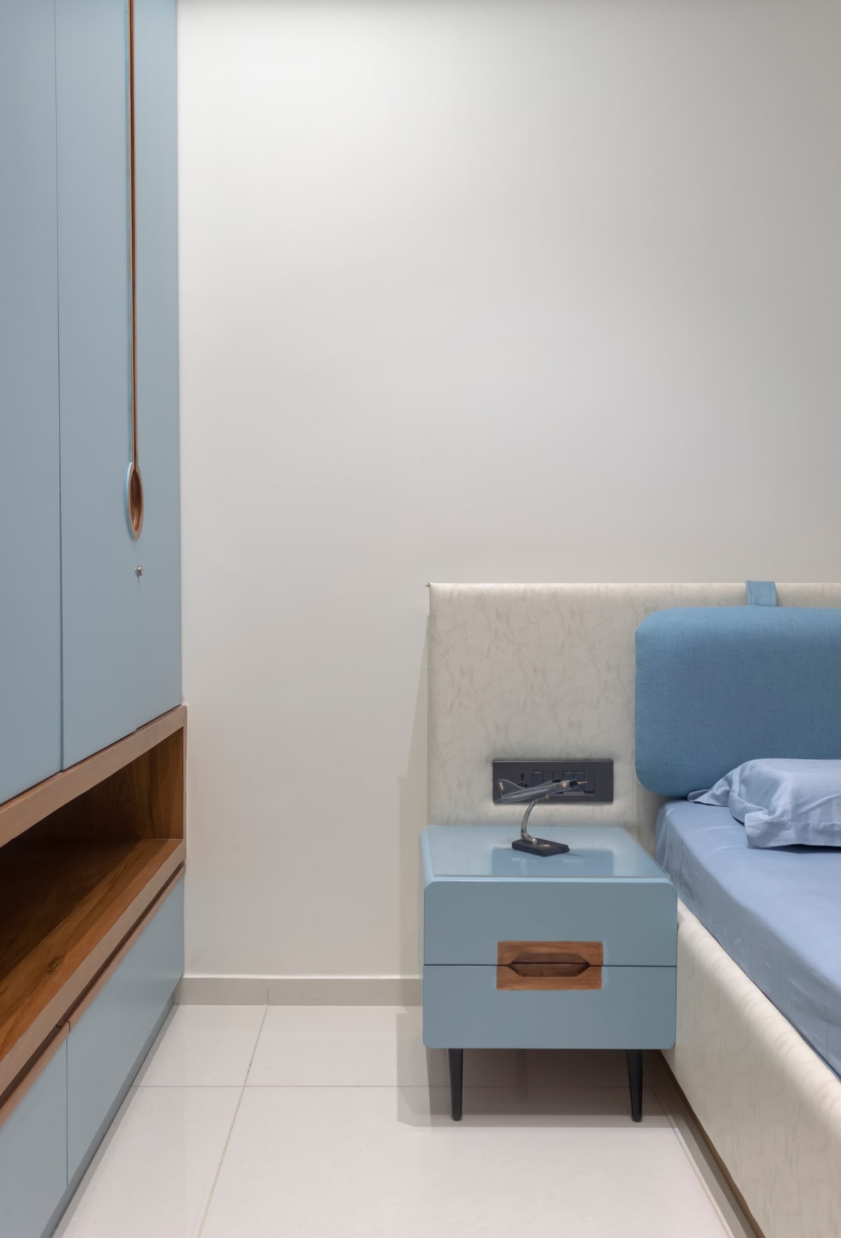 Bedroom with blue wardrobe and matching side table