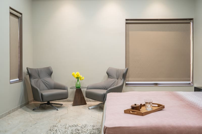 Bedroom seating area with two grey armchairs
