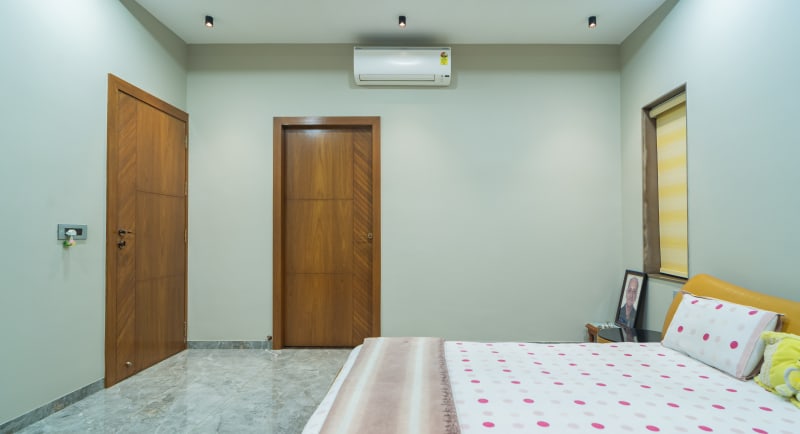 "Modern bedroom containing two wooden doors"