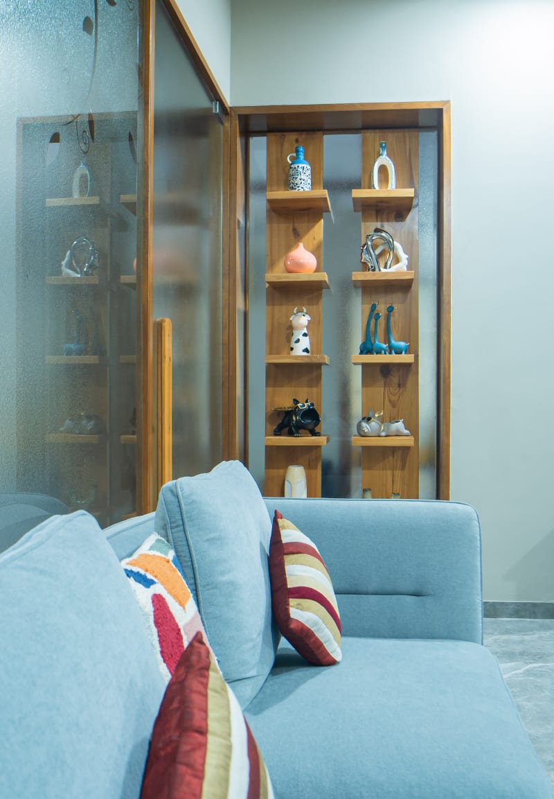 "Wooden display shelf next to sofa"