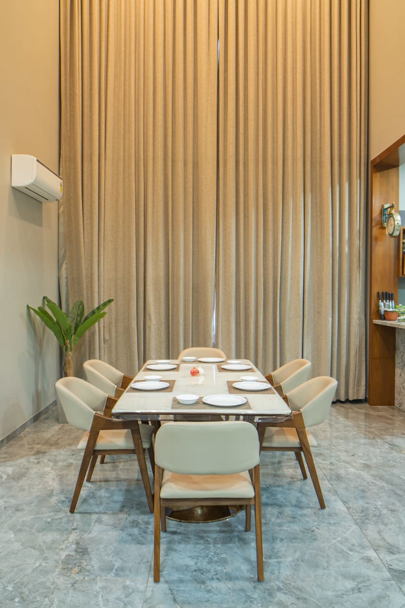 Dining table setup with tall curtains