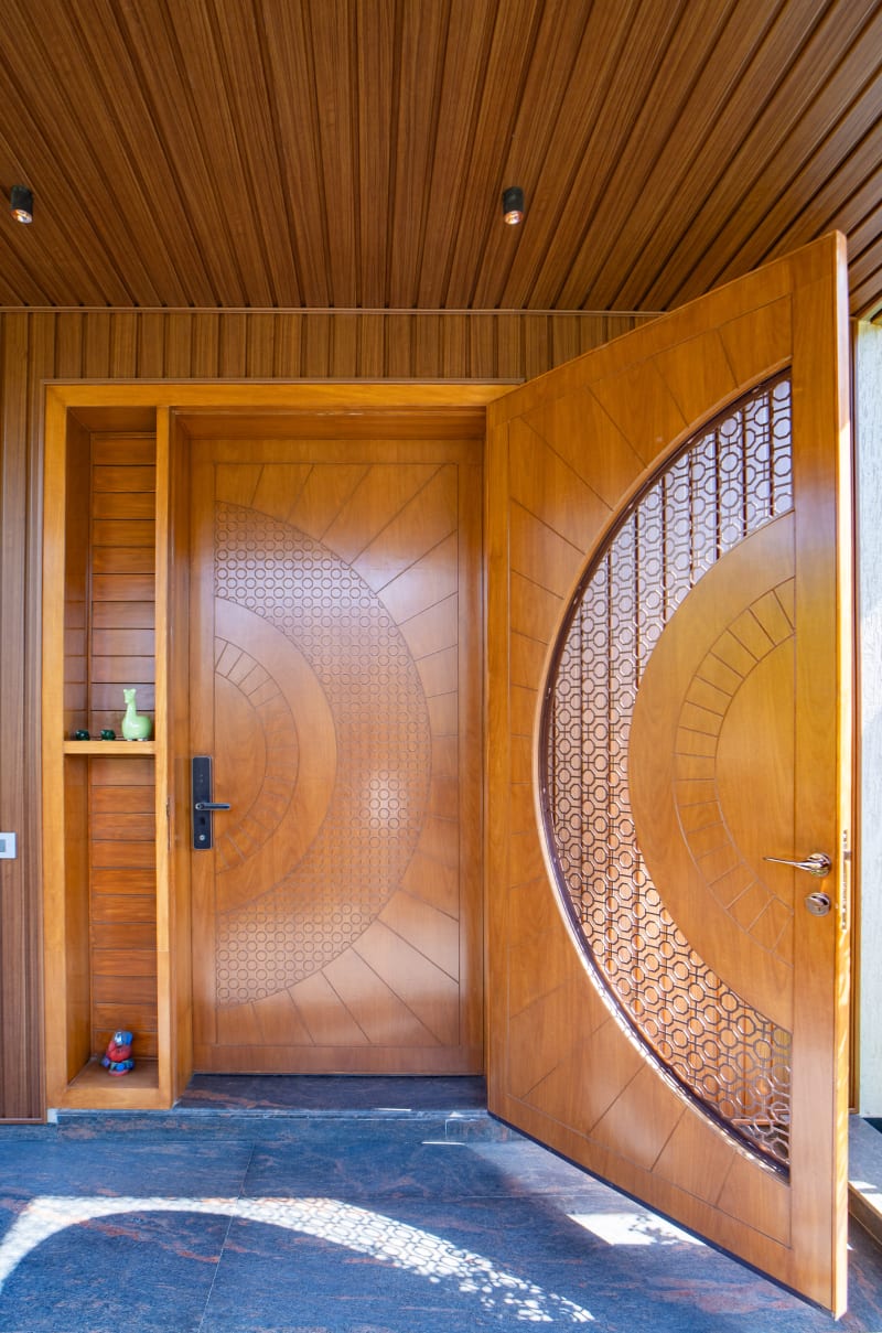 Intricately designed wooden main entrance door