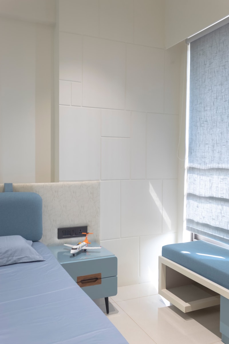 Bed side table with toy airplane and window seating