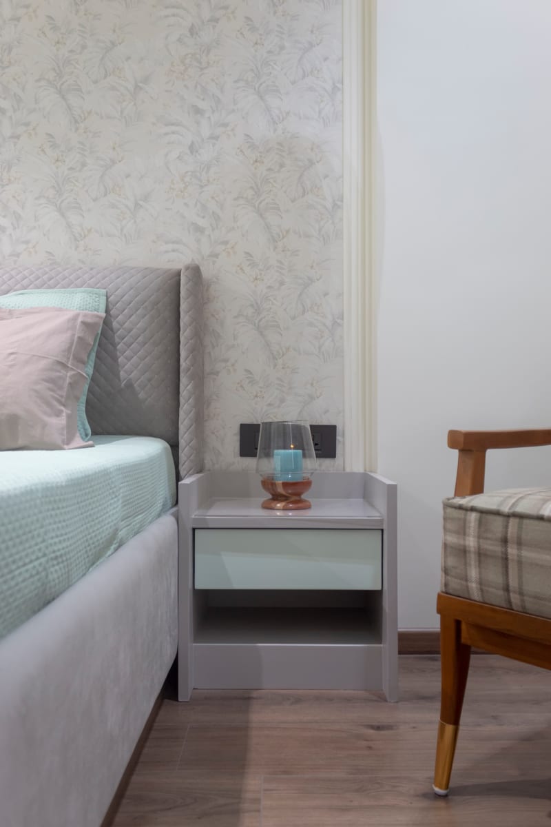 Grey bedroom side table and headboard detail