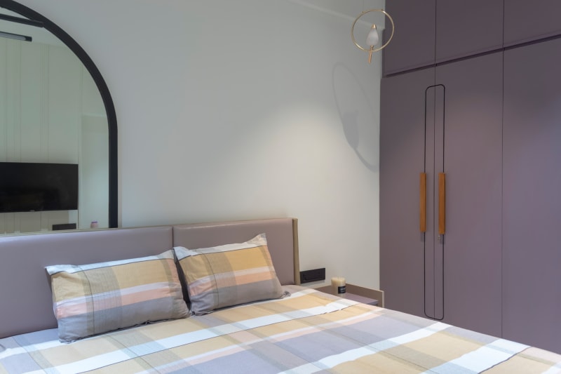 Bedroom with purple wardrobe and checkered bedsheet
