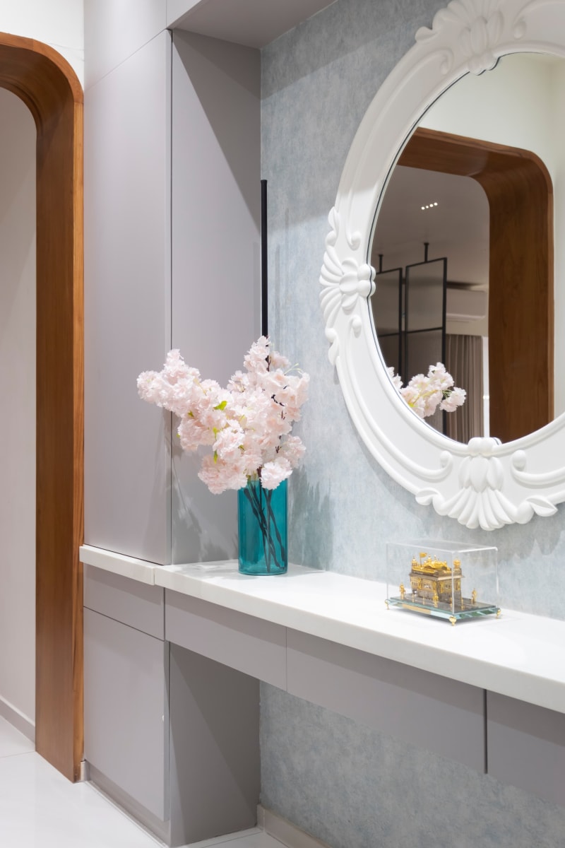 Console table with ornate mirror in corridor