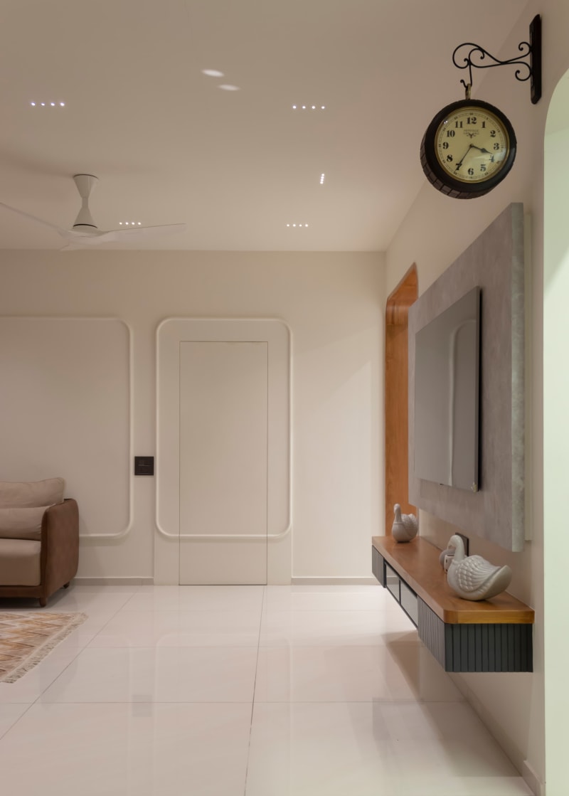 Corridor with minimalist white door and wall clock