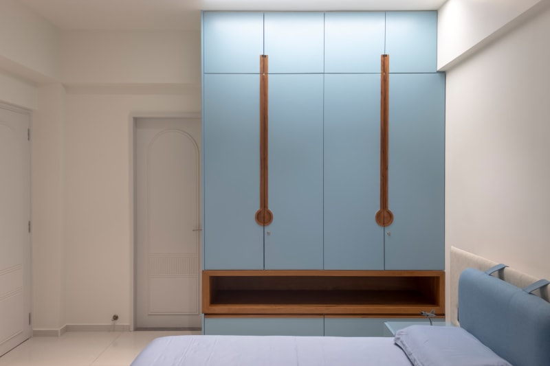 Bedroom with blue wardrobe and matching bed"
