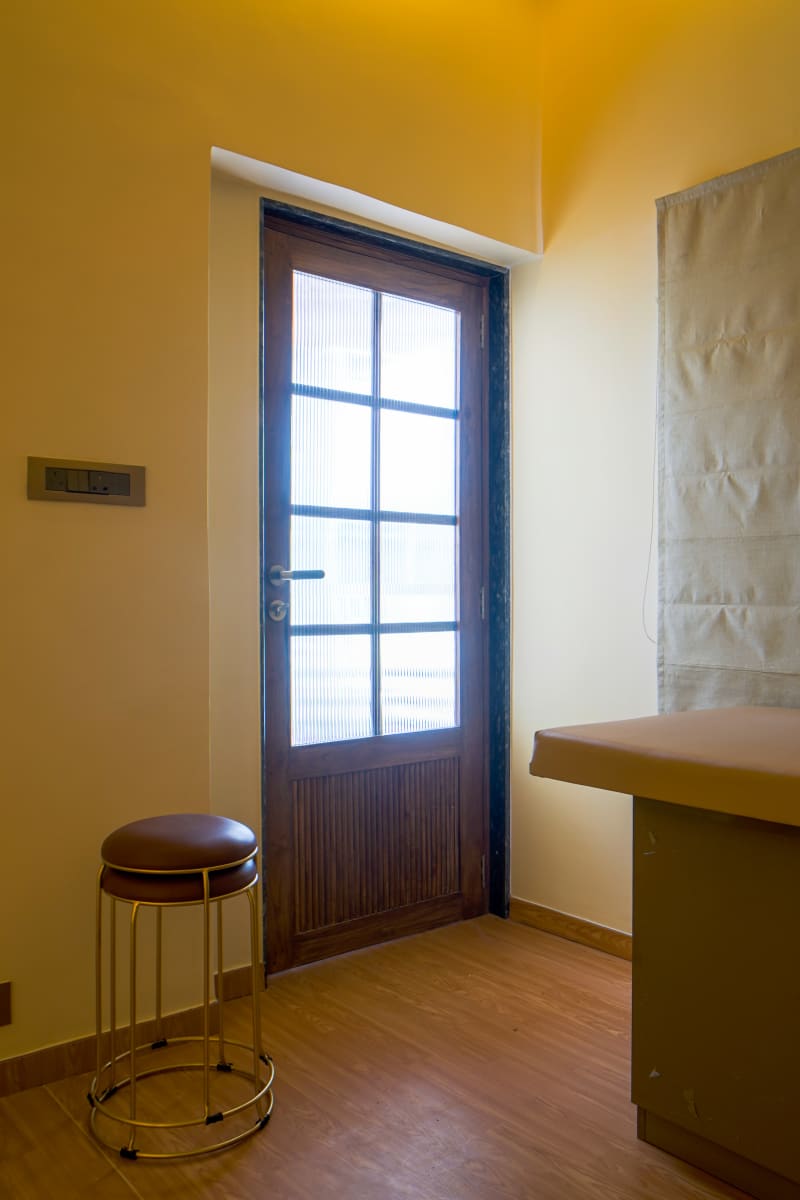 Glass door and stool in treatment room