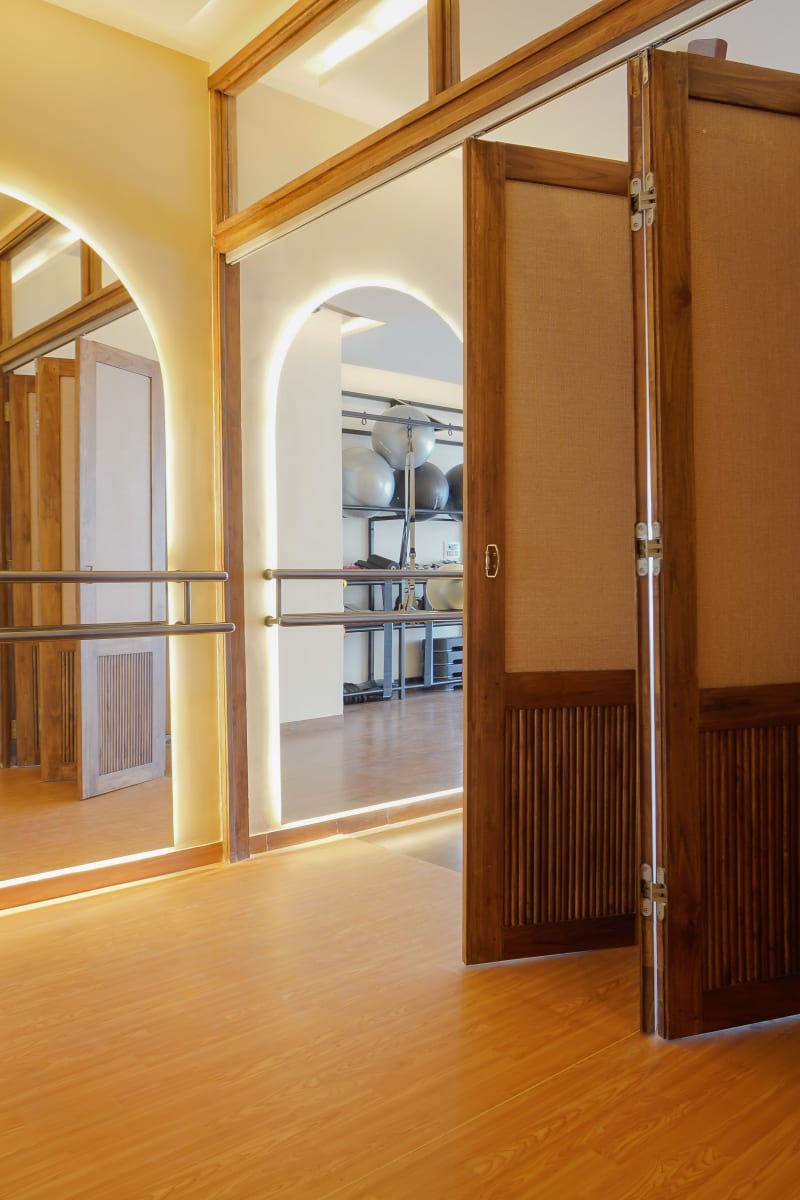 Partially open partition door and gym mirrors