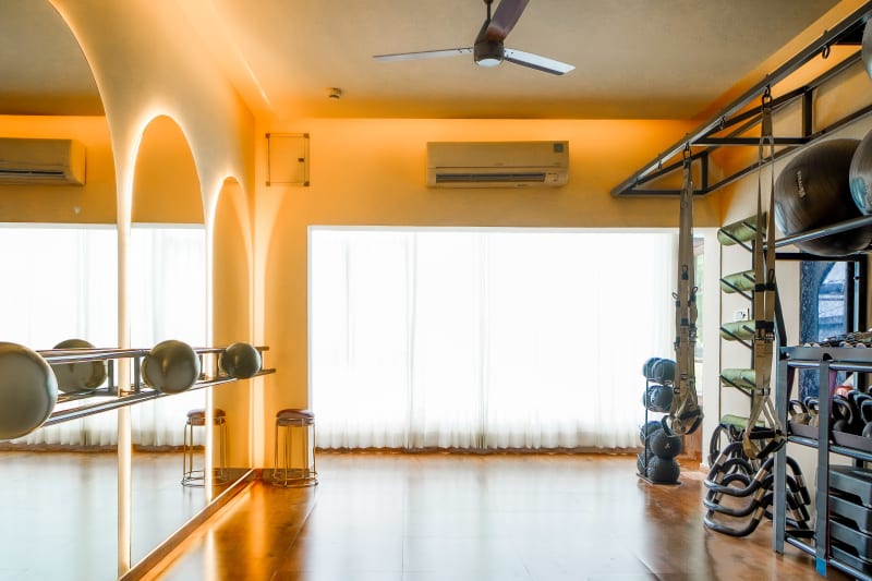 Rehabilitation gym area with mirrors and equipment