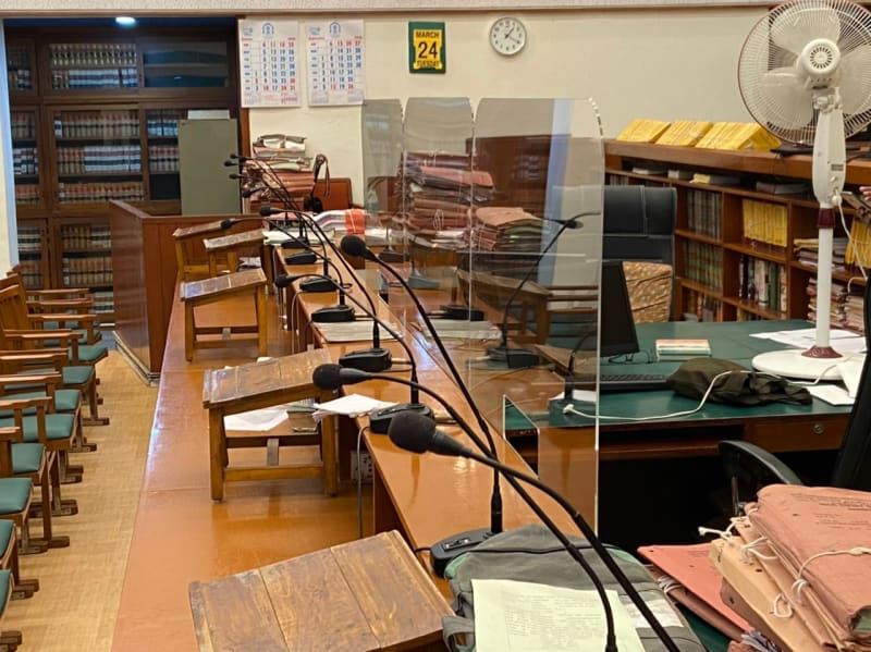 Courtroom desks with microphones and law books