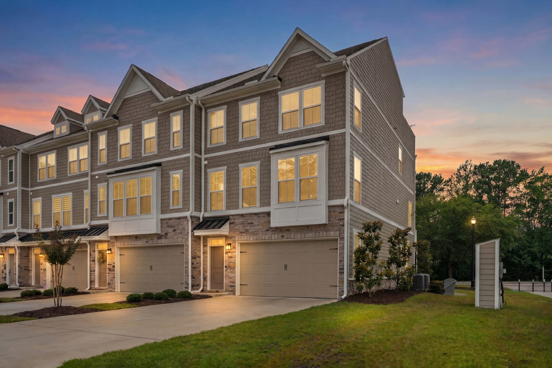 Unit 1001 at twilight, an end-unit townhome with a two-car garage, 2557 Pete Dye Dr Unit 1001