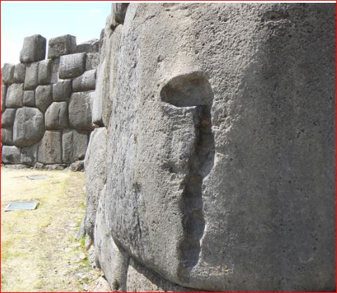 "Close-up of the massive precisely fitted polygonal Inca stone walls at Sacsayhuamán, Peru, showcasing the incredible craftsmanship and tight joints between enormous boulders."