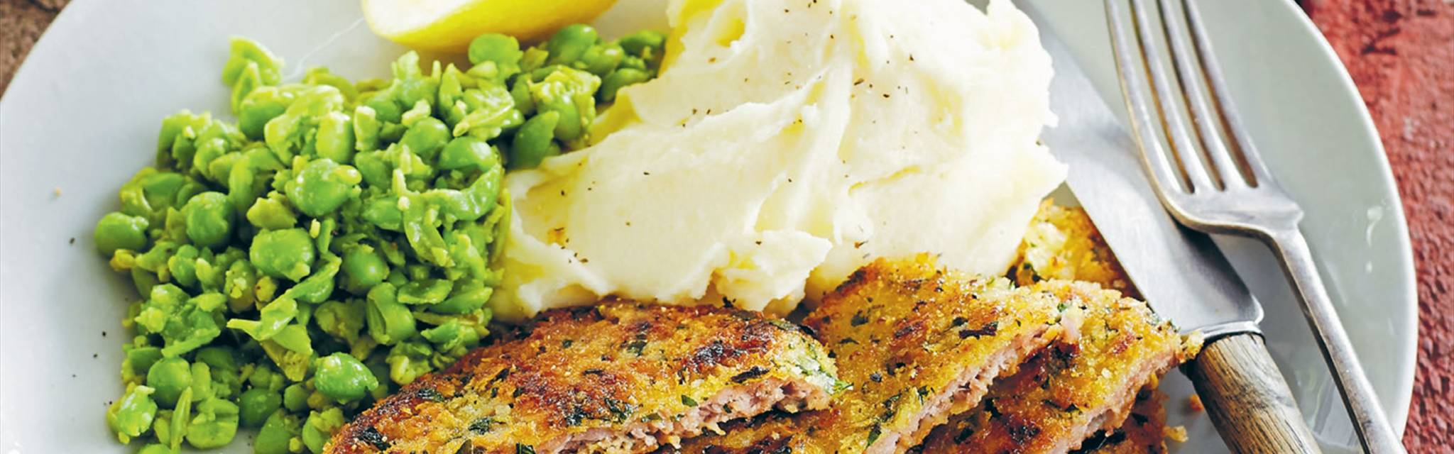 Veal schnitzel with mashed potato and smashed peas