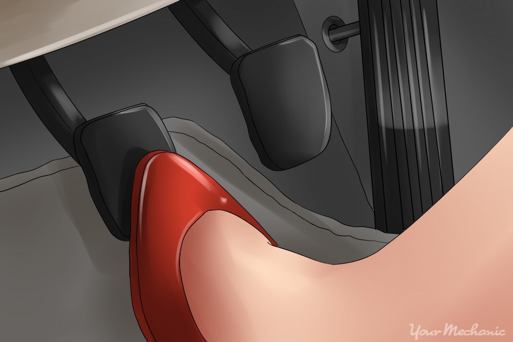 picture of foot depressing the clutch pedal