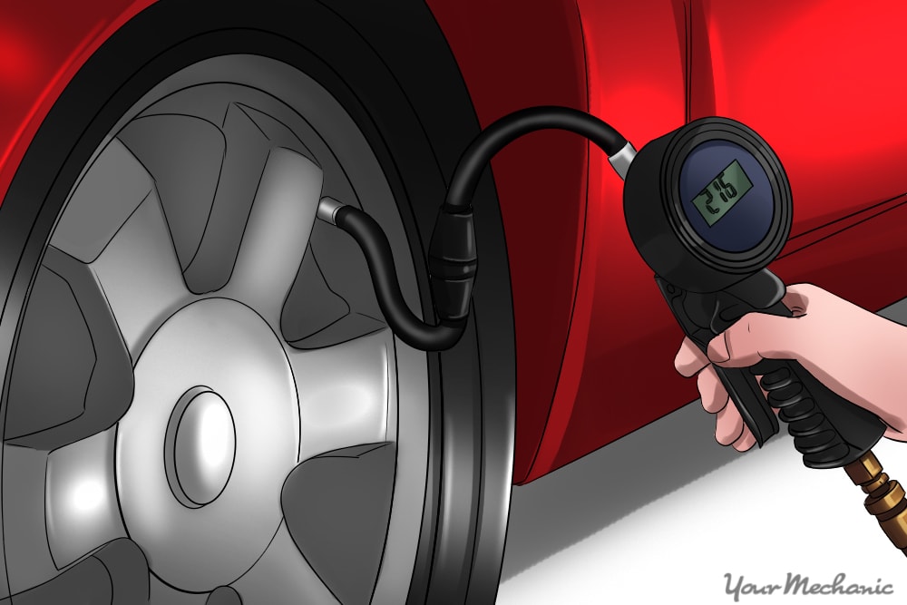 person using a tire pressure gauge