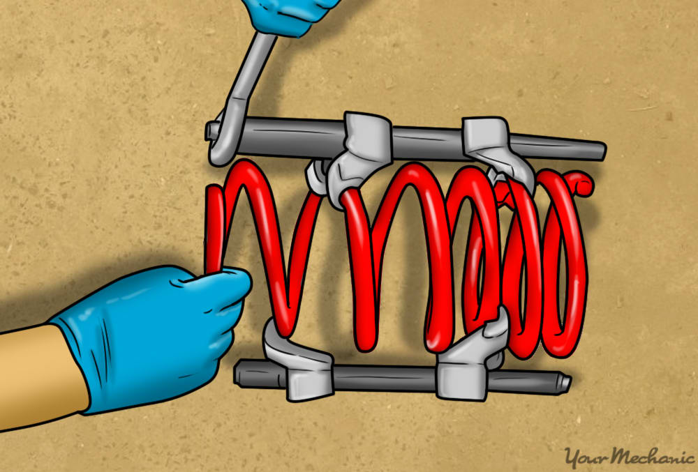 compressing new spring with spring compressors