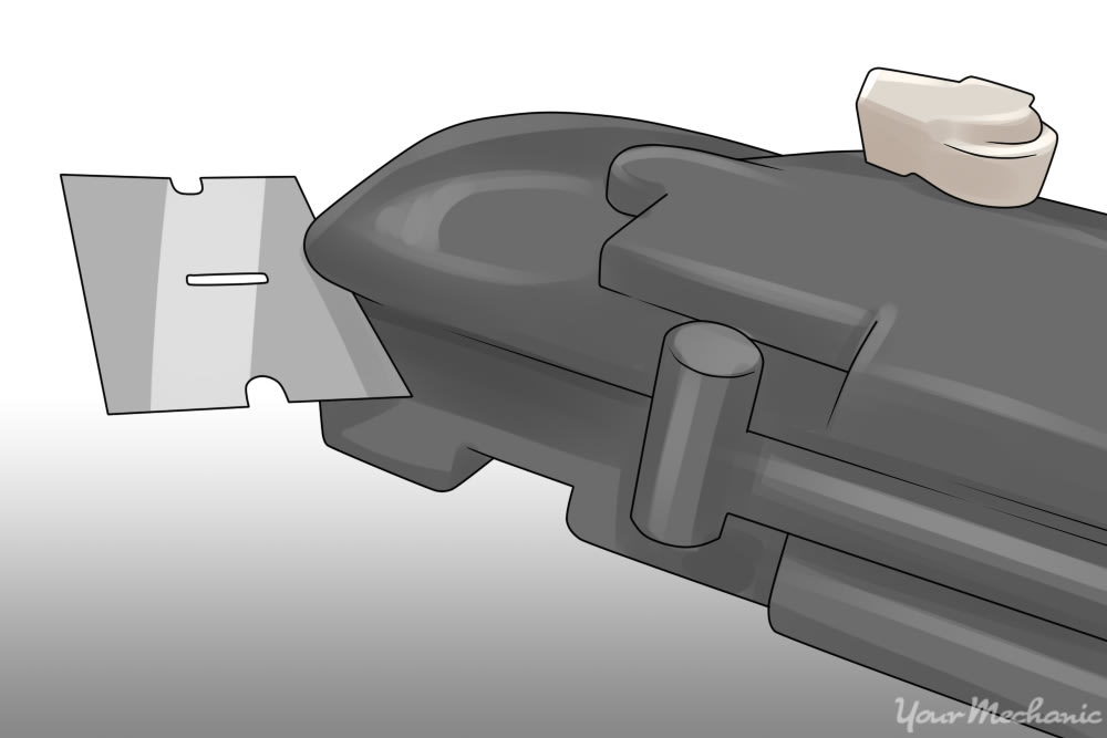 razor blade being used to slice open the seam of a plastic actuator