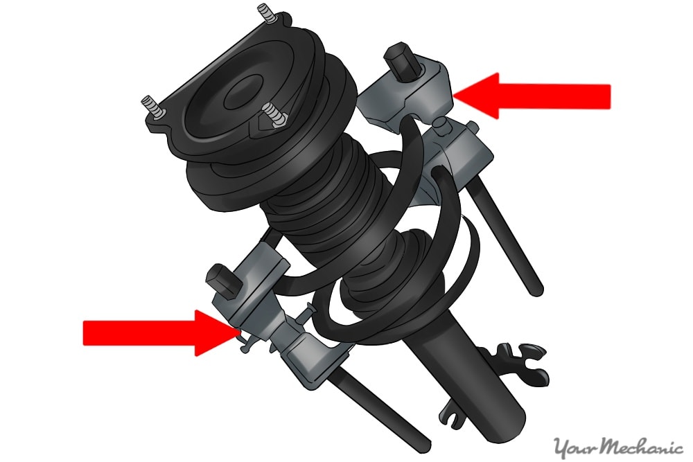 spring compressor mounted to a strut assembly