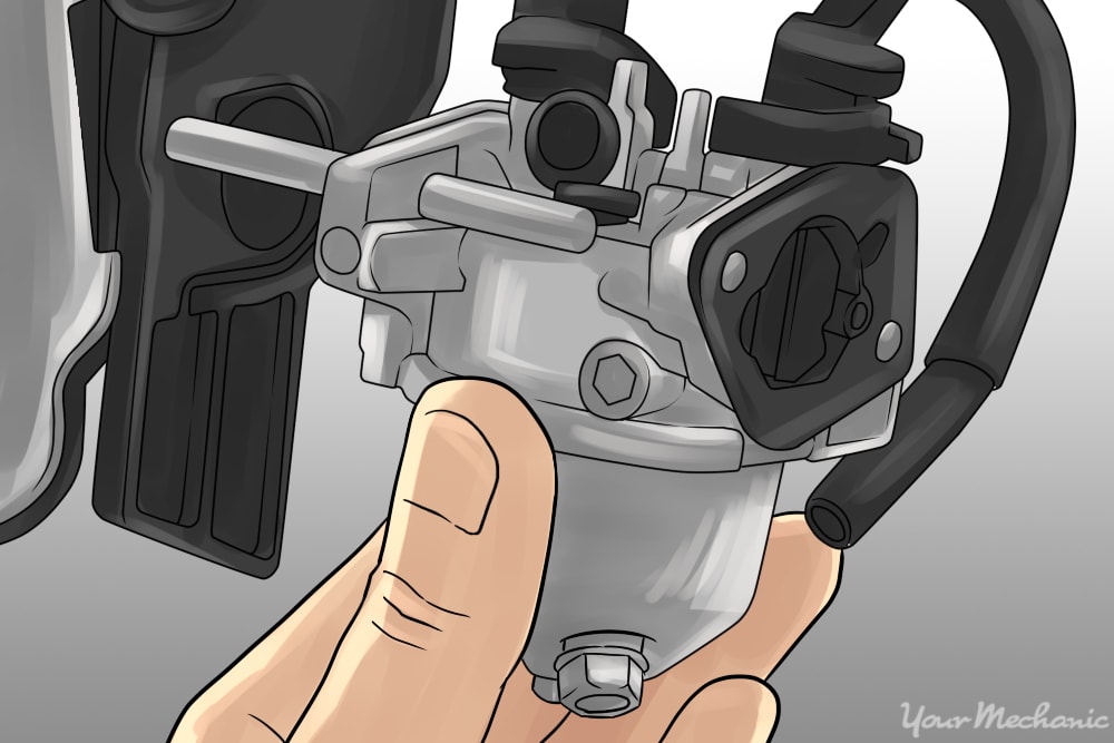 mechanic seperating carburetor from the intake manifold