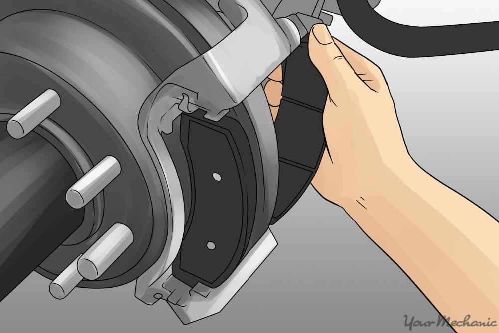 person installing new brake pads