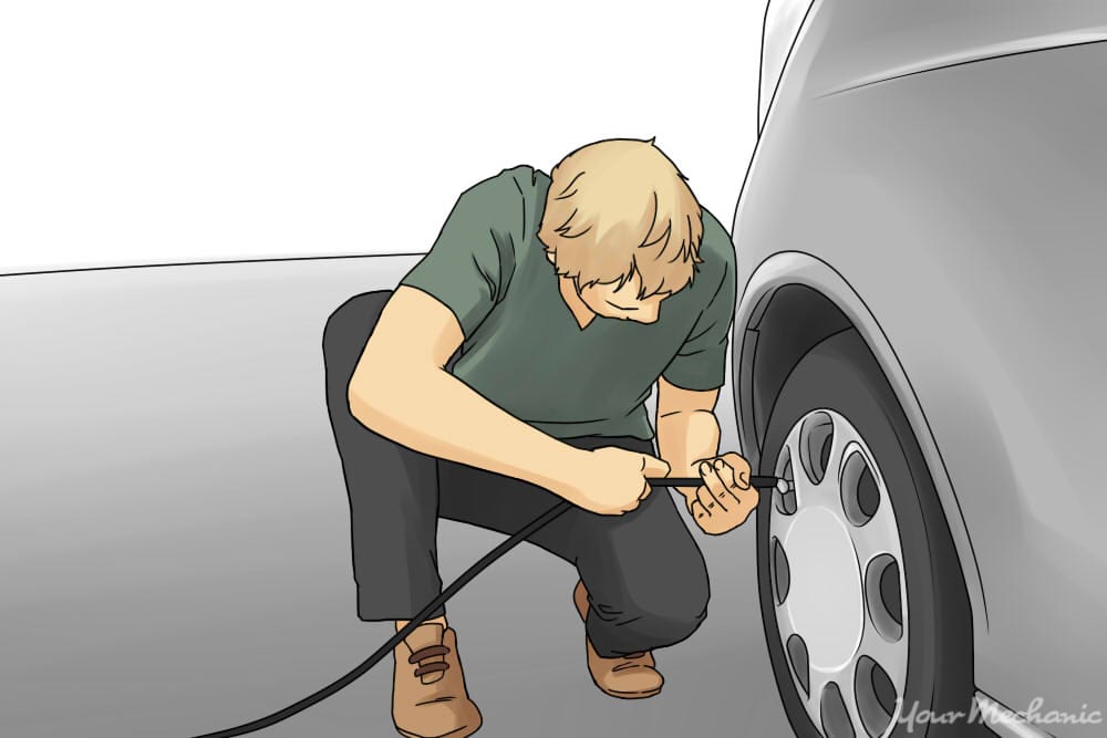 1 How To Check And Add Air To Tires Man Kneeling Down Adding Air To A Tire With A Hose