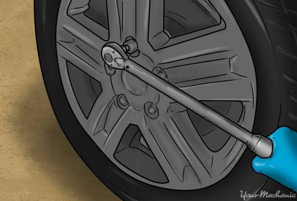 hand using tool to torque the wheels down