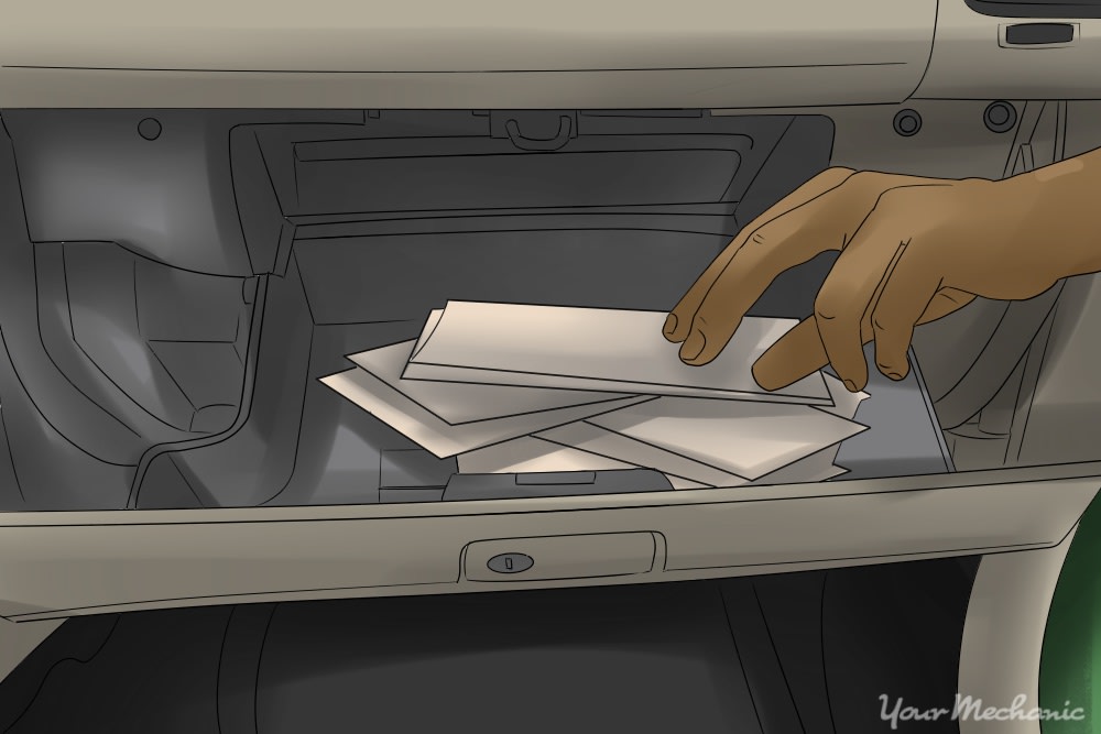 person removing items from glove box