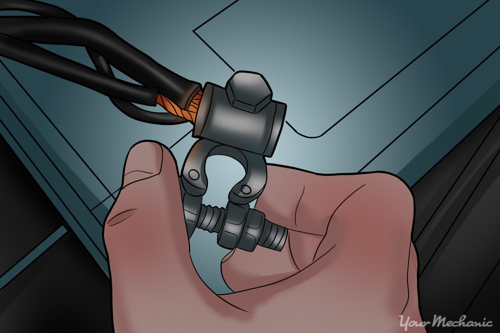 hand removing the negative terminal of the battery