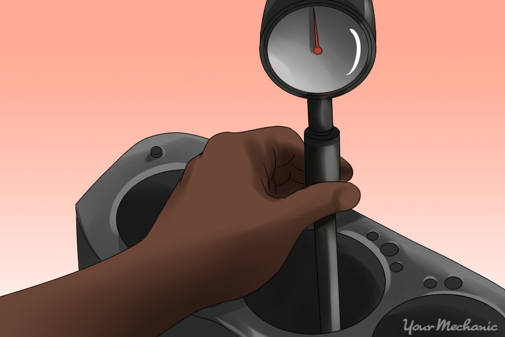 person inserting and reading the dial bore gauge