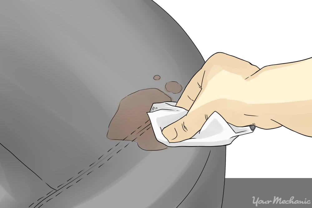 person using cloth to absorb liquid