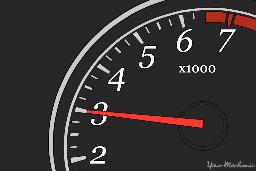 tachometer with black face and red needle