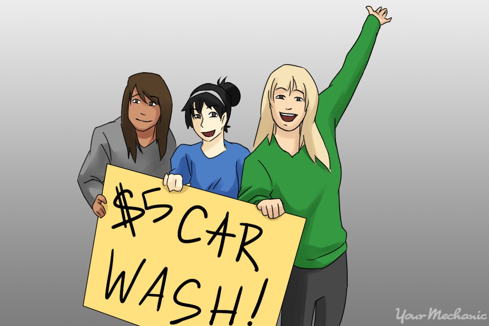 girls holding car wash sign