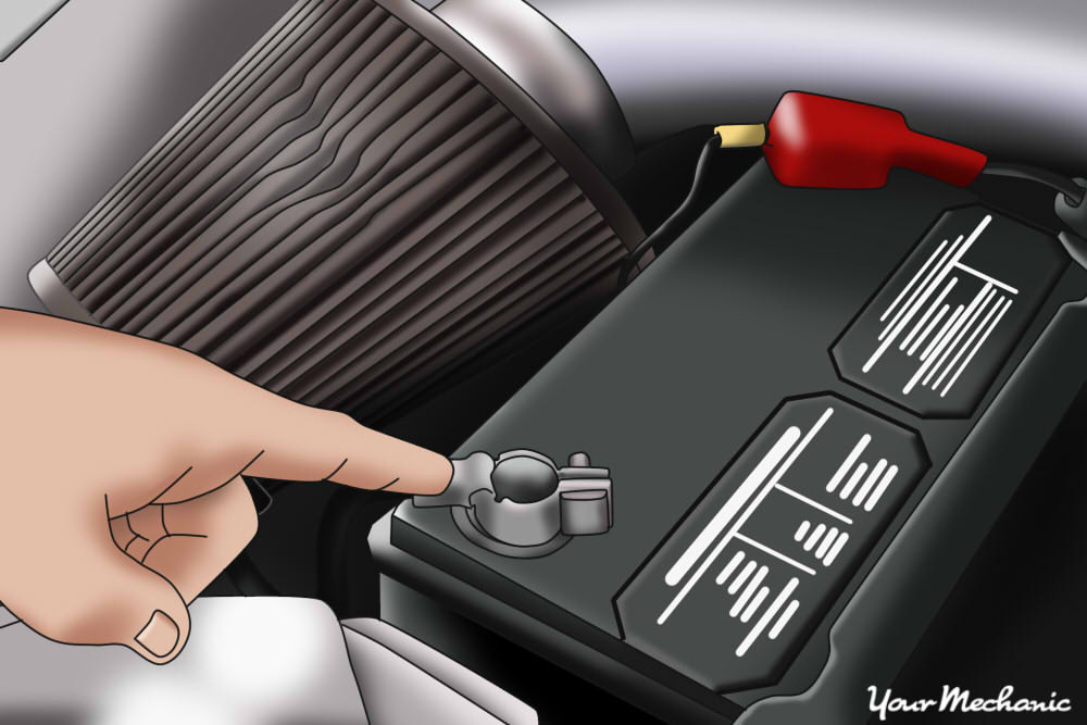 person pointing at black terminal of car battery