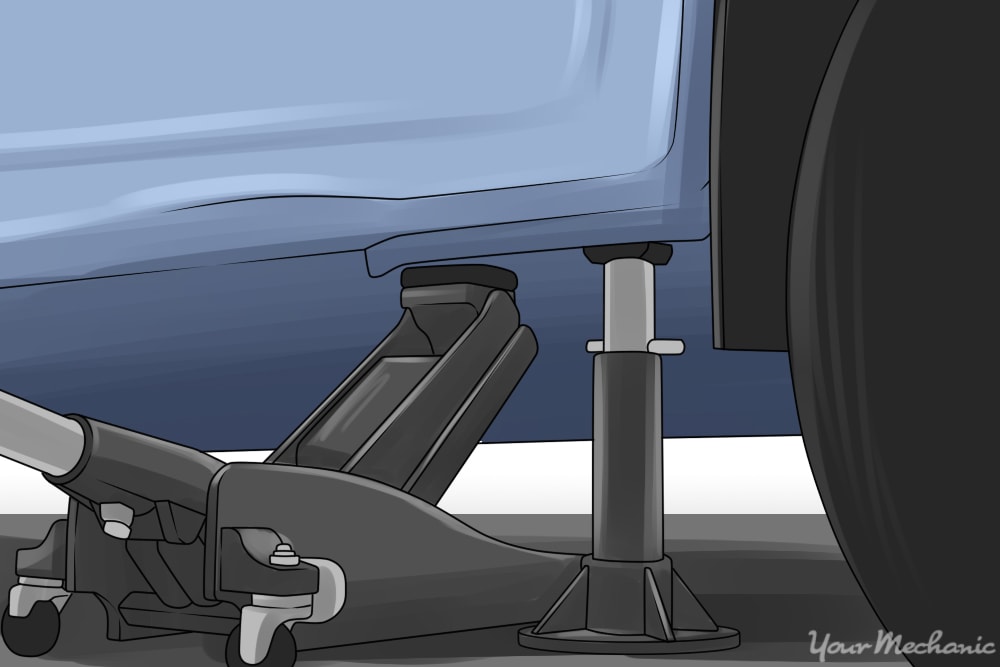 hydraulic jack and jack stand holding up a vehicle