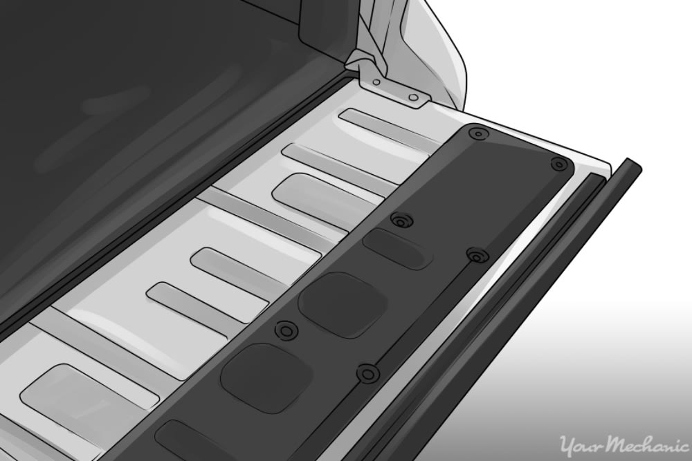 back of tailgate showing the access panel and the screws holding the panel in place