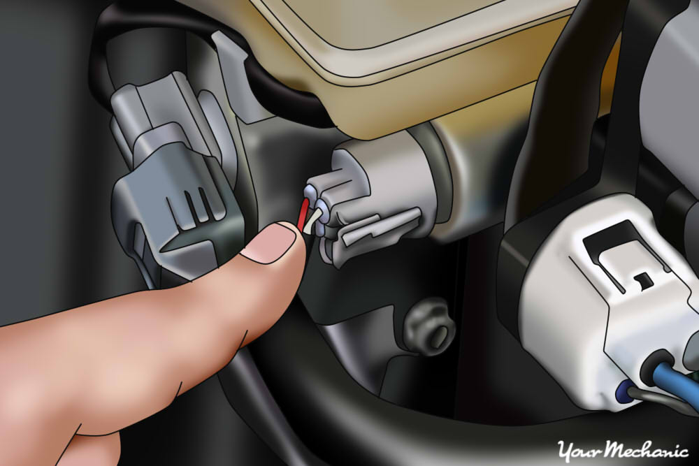 picture of mechanic pointing to anti-lock brake pressure switch mounted to master cylinder