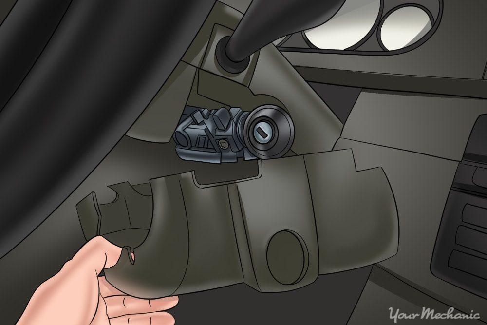 removing the upper and lower steering column trim cover to gain access to the ignition lock cylinder