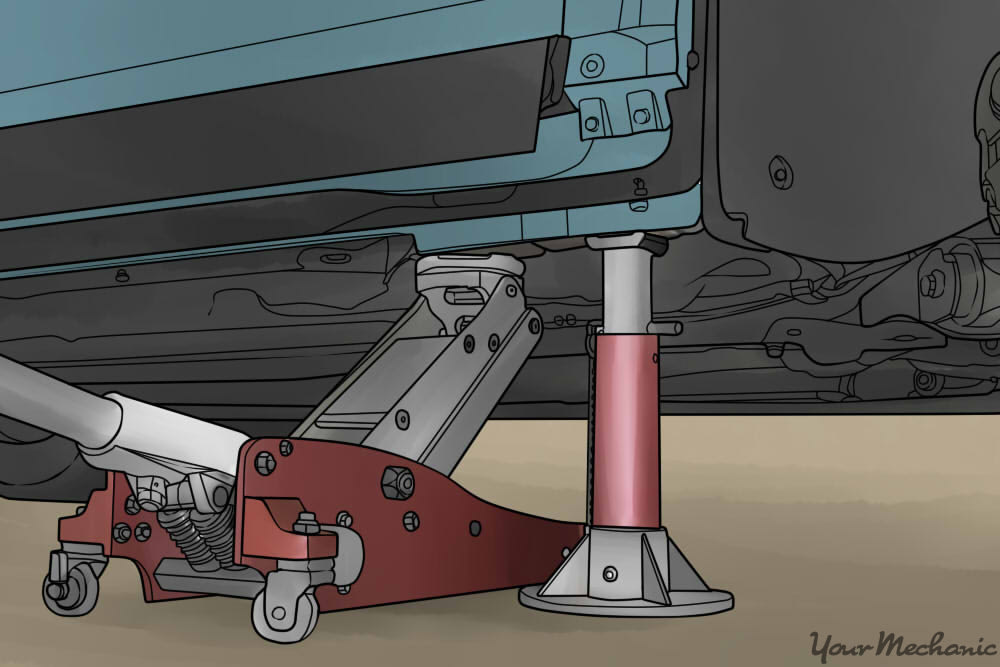 hydraulic jack and jack stand holding up a vehicle