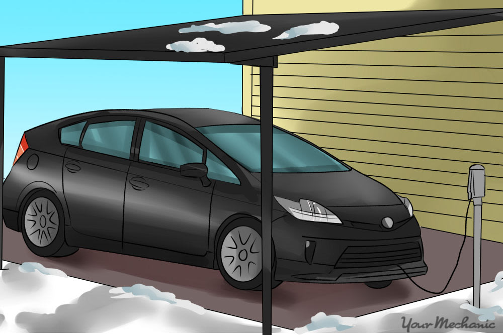 car parked under a carport with a battery heater plugged in