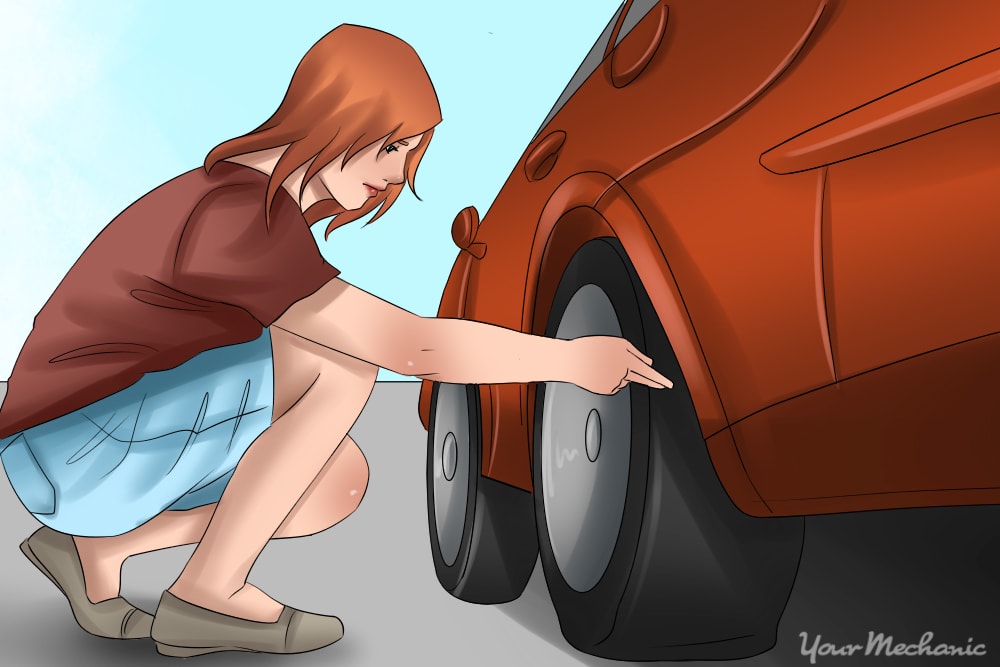 woman inspecting tire with no tools