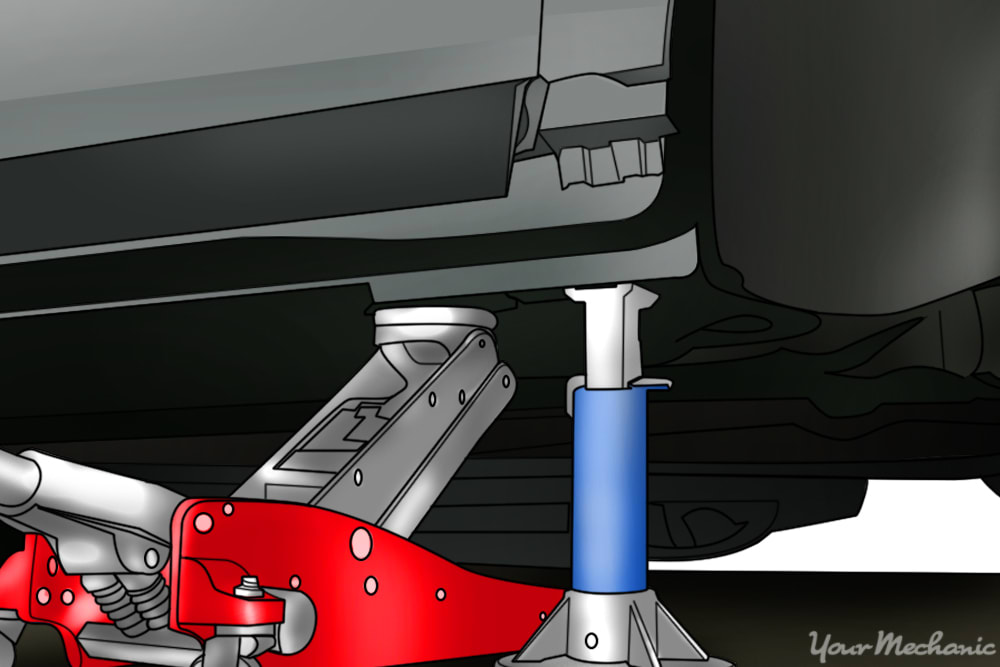 hydraulic jack and jack stand holding up a vehicle