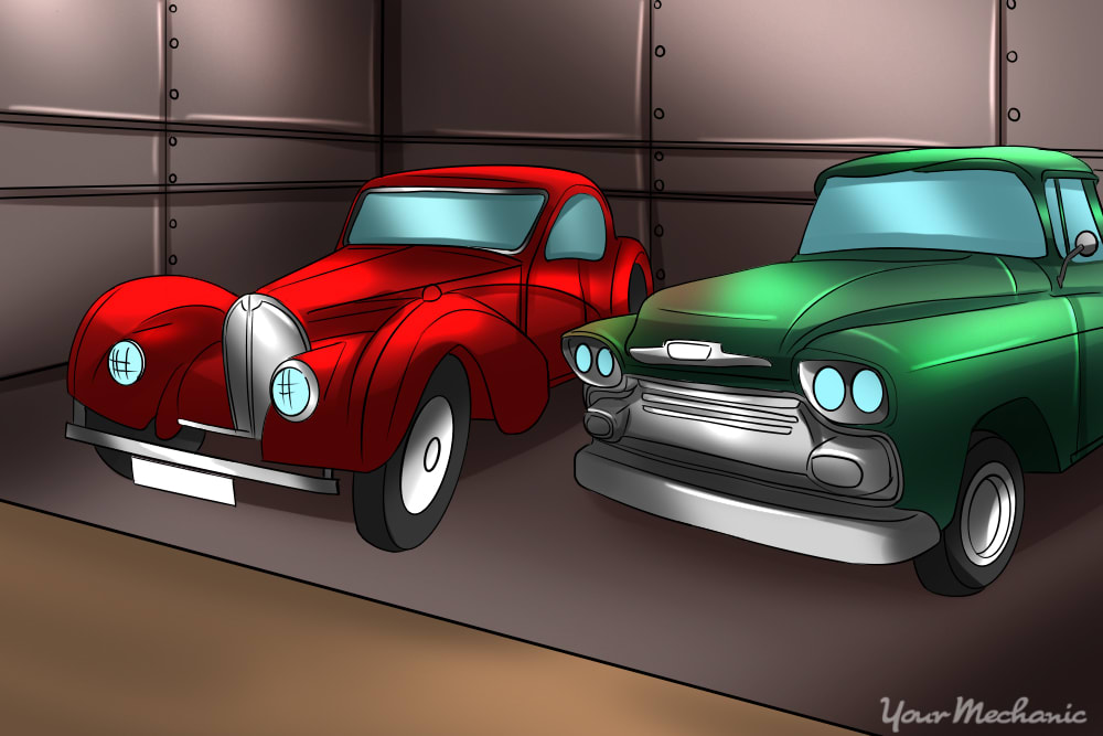 classic cars sitting in an old garage