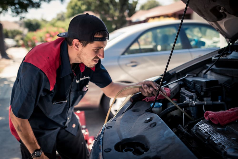 mechanic holding hose