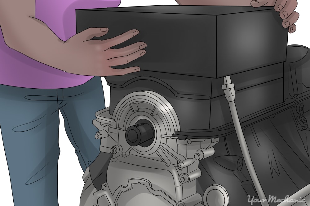 person installing oil pan