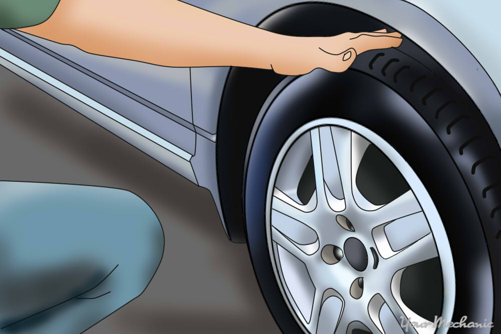 person inspecting car tire